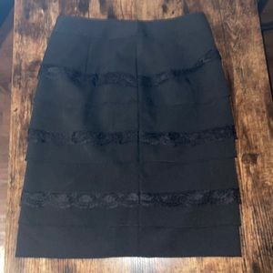 Gorgeous black pencil skirt with black lace accent size 4 new condition.